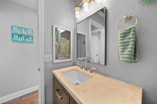 bathroom featuring vanity and wood-type flooring