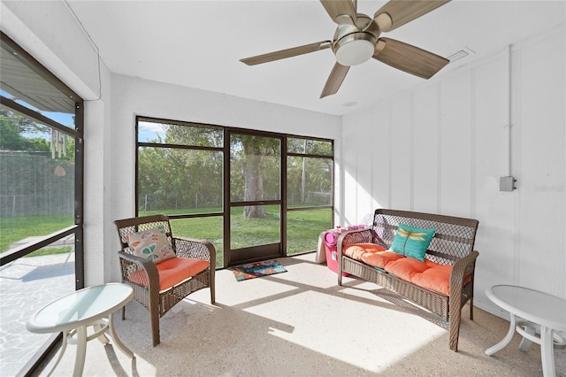 sunroom / solarium featuring ceiling fan