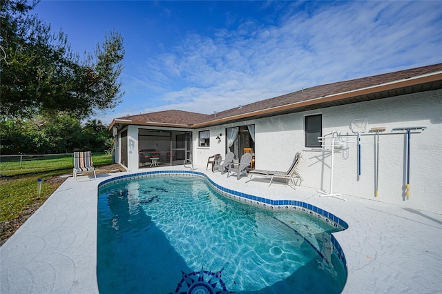 view of pool featuring a sunroom and a patio area