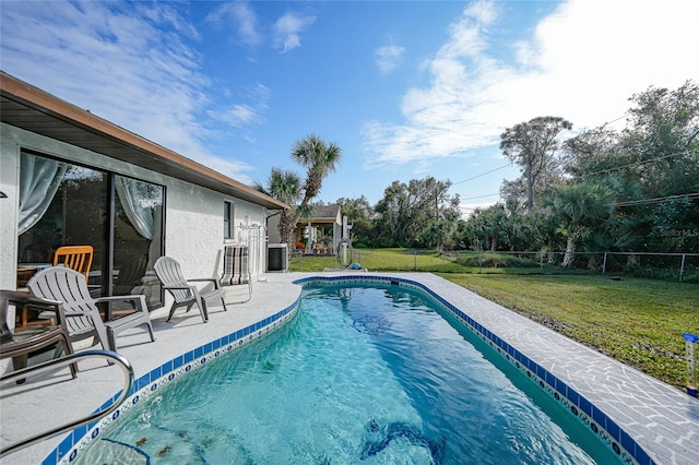 view of pool featuring a lawn and a patio area