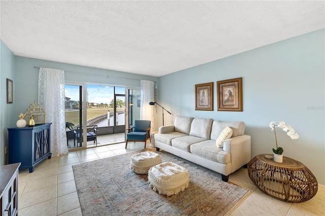 tiled living room featuring a textured ceiling