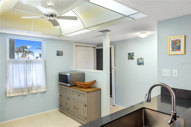 kitchen with ceiling fan and sink