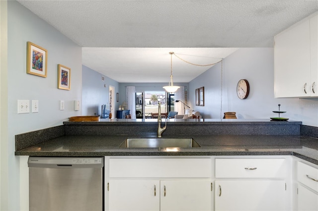 kitchen with white cabinetry, dishwasher, and a textured ceiling