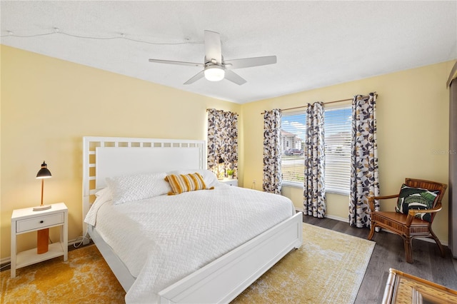 bedroom with ceiling fan and hardwood / wood-style flooring