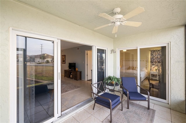 sunroom / solarium featuring ceiling fan