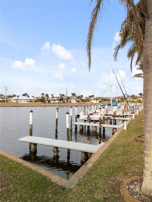 dock area featuring a water view and a yard