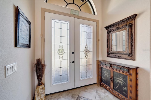 entryway featuring a wealth of natural light and french doors