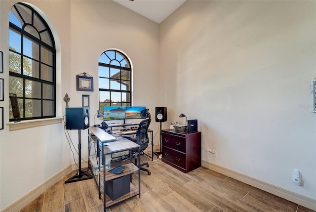 home office with light hardwood / wood-style flooring