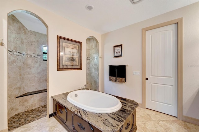 bathroom with tile patterned floors and shower with separate bathtub