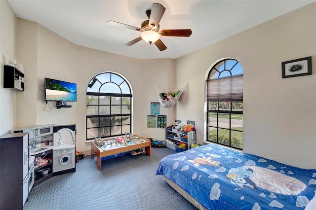 carpeted bedroom with multiple windows and ceiling fan