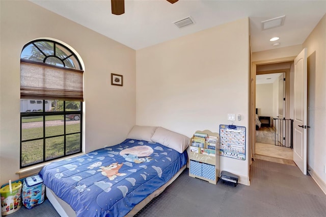 bedroom featuring ceiling fan and multiple windows