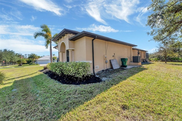 view of home's exterior with a yard and central air condition unit