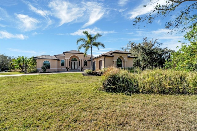 mediterranean / spanish house featuring a front lawn