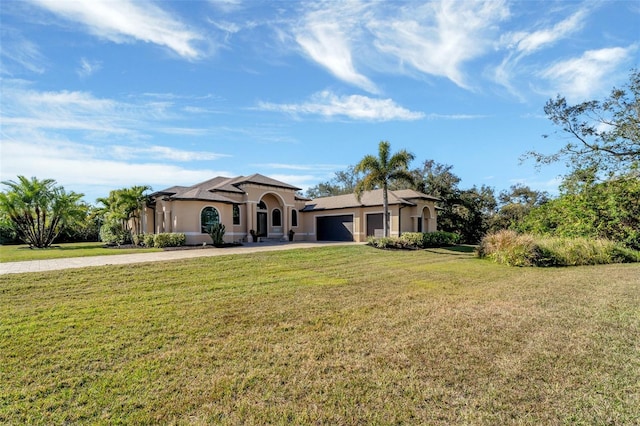 view of front of property featuring a garage and a front lawn