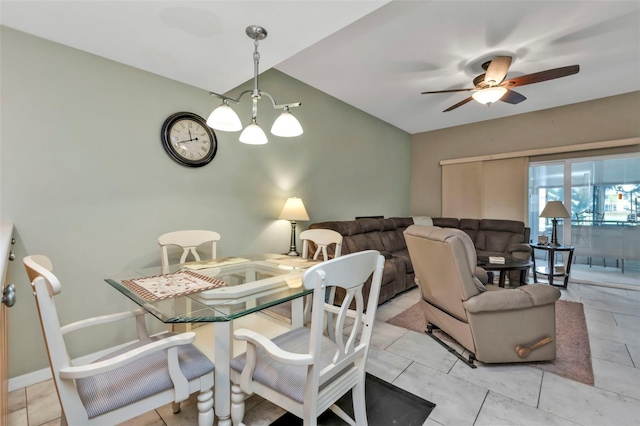 dining room featuring ceiling fan with notable chandelier