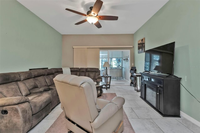 living room featuring light tile patterned floors and ceiling fan