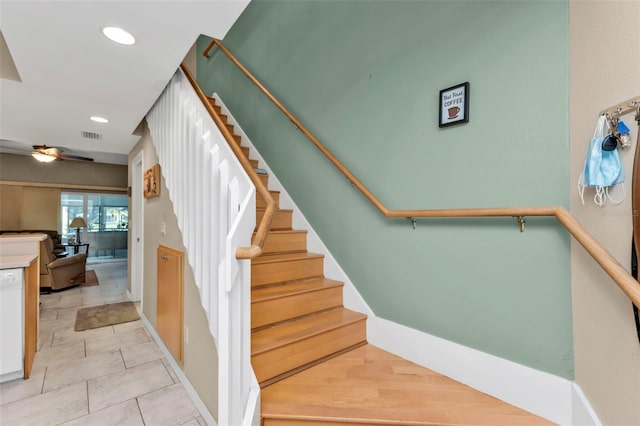 stairs with tile patterned floors and ceiling fan