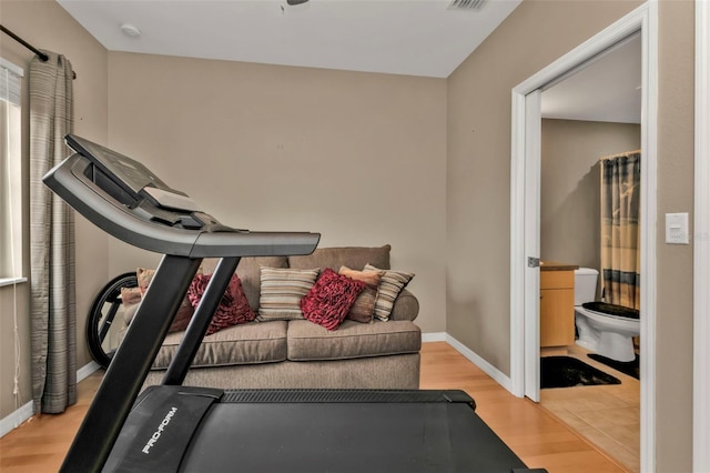 exercise room with light hardwood / wood-style floors