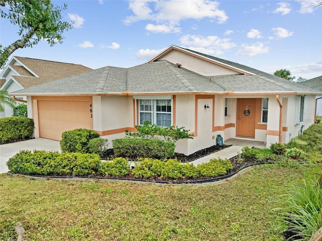 ranch-style house featuring a garage and a front lawn