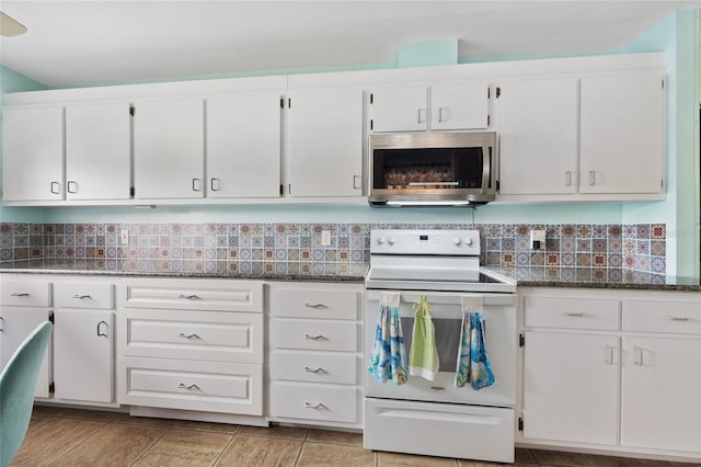 kitchen with dark stone counters, white electric range oven, decorative backsplash, and white cabinets