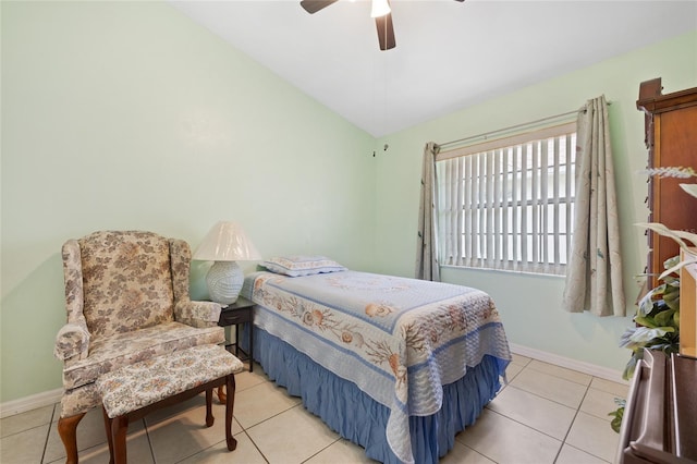 bedroom featuring lofted ceiling, light tile patterned floors, and ceiling fan