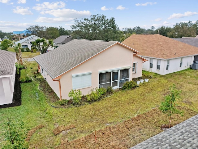 exterior space featuring central AC and a lawn