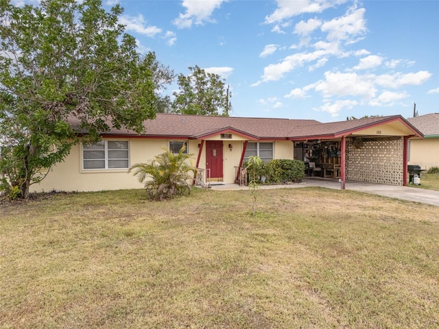 ranch-style house featuring a carport and a front yard