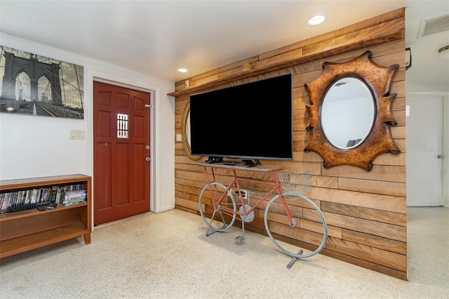 living room with wood walls