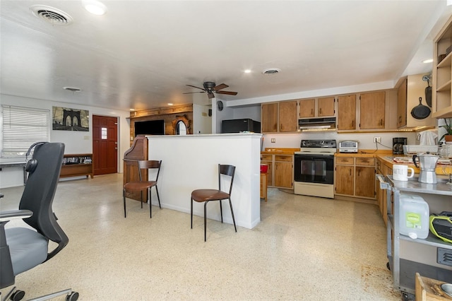 kitchen with a kitchen breakfast bar, range with electric cooktop, and ceiling fan