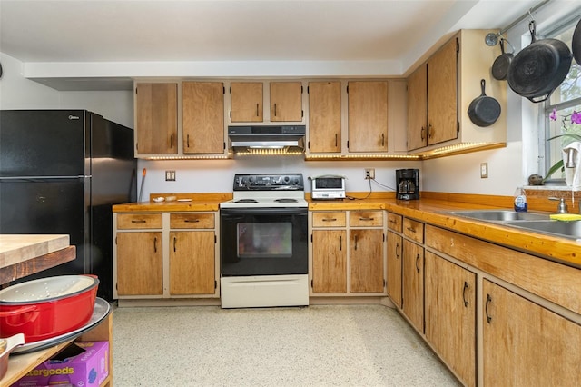 kitchen featuring black refrigerator, sink, and electric range