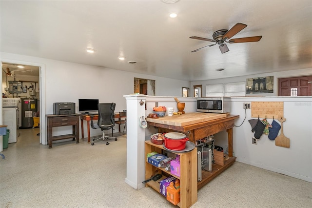 kitchen featuring wood counters, washer / dryer, electric water heater, and ceiling fan