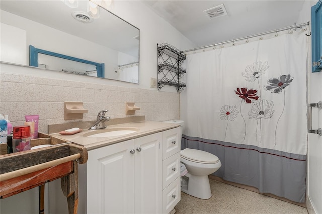 bathroom featuring vanity, backsplash, and toilet