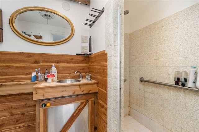 bathroom featuring vanity and tiled shower