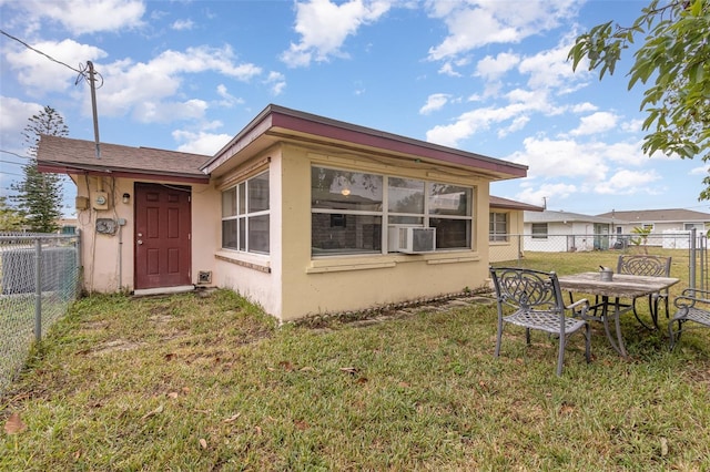 back of house featuring a yard and central AC unit