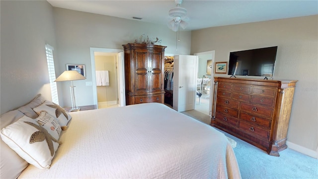 bedroom with ceiling fan, light colored carpet, and a closet