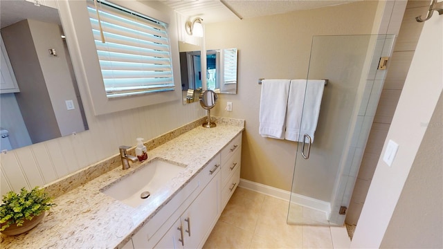 bathroom featuring vanity, tile patterned flooring, and a shower with door