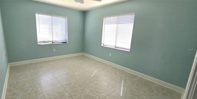 unfurnished room featuring light tile patterned floors and ceiling fan