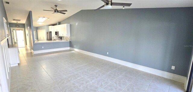 tiled spare room featuring lofted ceiling and ceiling fan