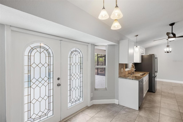 interior space featuring french doors, ceiling fan, vaulted ceiling, and sink