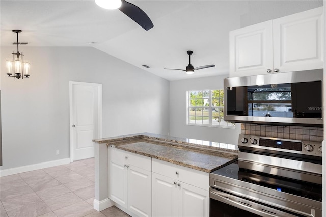 kitchen featuring vaulted ceiling, white cabinetry, appliances with stainless steel finishes, and ceiling fan with notable chandelier