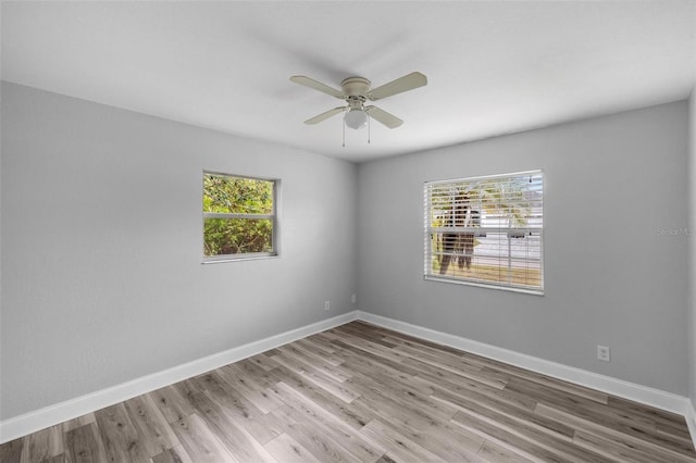 spare room with ceiling fan, plenty of natural light, and light hardwood / wood-style floors