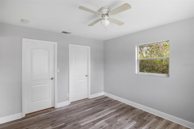 unfurnished bedroom featuring hardwood / wood-style flooring and ceiling fan