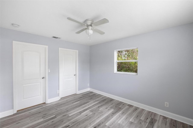 spare room featuring ceiling fan and light wood-type flooring