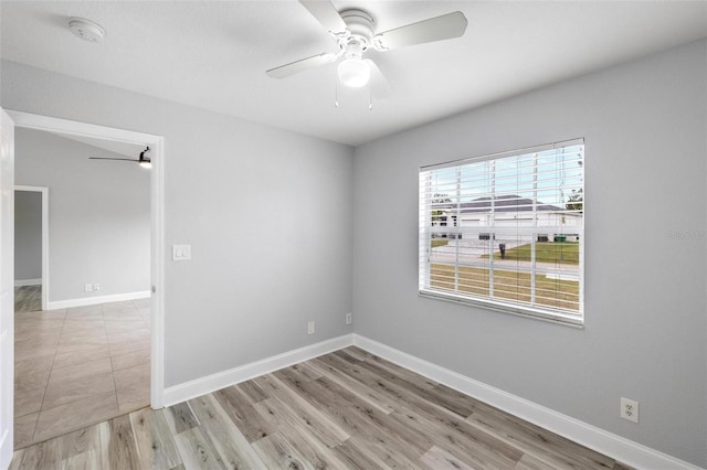 empty room with ceiling fan and light wood-type flooring