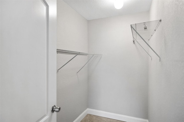 walk in closet featuring tile patterned flooring