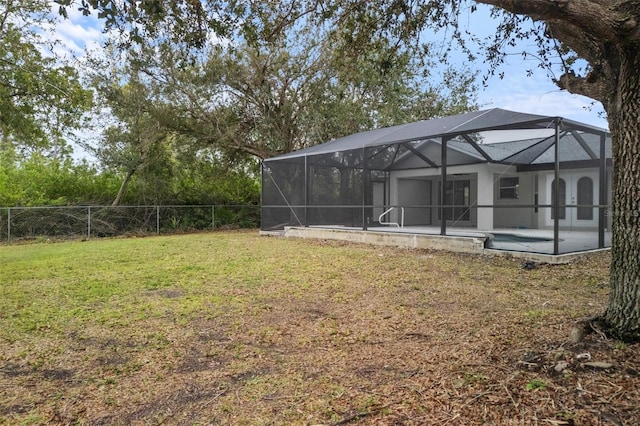 view of yard featuring a lanai, a patio area, and a swimming pool