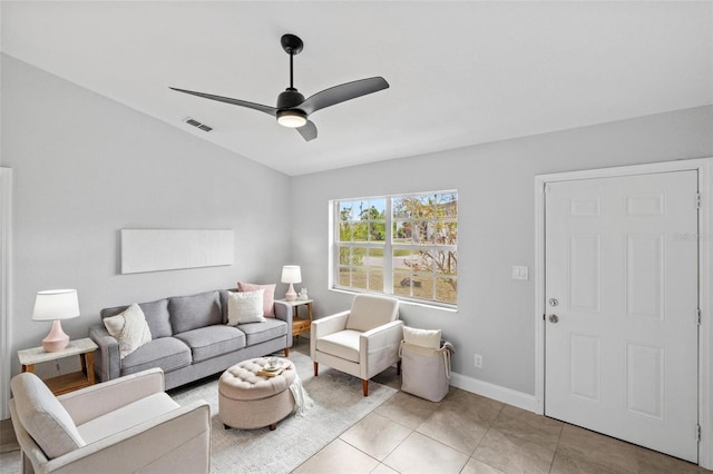 living area featuring light tile patterned floors, baseboards, visible vents, and a ceiling fan