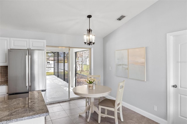 dining room with baseboards, visible vents, lofted ceiling, a notable chandelier, and light tile patterned flooring