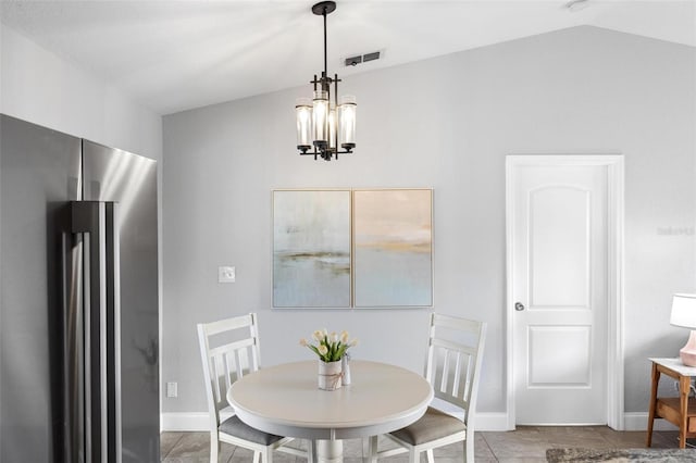 tiled dining area featuring a chandelier, visible vents, vaulted ceiling, and baseboards