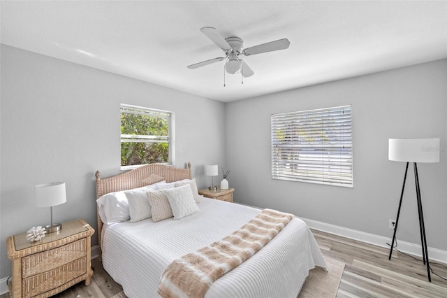 bedroom featuring light wood-style floors, ceiling fan, and baseboards